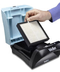 Hand inserting EPA E10 Particulate Filter With Activated Carbon Granules For Gas For Zero Smog Shield Pro into benchtop unit.