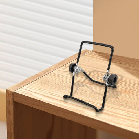 Two Pack Foldable Solar Panel Mounting Brackets With Adjustable Stands for 130x90 mm panels on wooden surface.