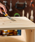 Person using tool on wood surface for Stainable Wood Filler 6 Oz For Cracks And Gouges Paintable Latex Wood Filler Indoor Outdoor