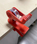 Versatile Adjustable Tape Dispenser With Precision Ribbon Cutter And Tough Locking Clip For Boss Mode desk organization on wood surface.