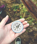 Must-Have 100mm Large Pocket Compass For Camping And Hiking held in hand outdoors