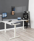 Super Smooth White Corner Standing Desk With Dry Erase Surface L Shaped Sit Stand Workstation 83 By 60 Inches in an office setting.