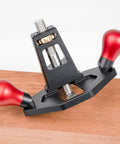 Tough As Nails Handheld Router Plane Featuring Adjustable Stainless Steel And Ebony Blades on smooth wood surface.