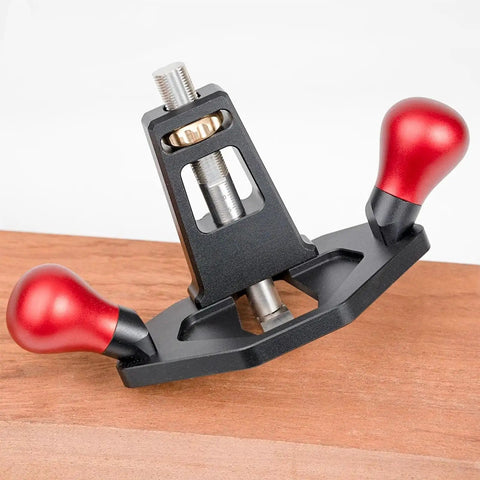 Tough As Nails Handheld Router Plane Featuring Adjustable Stainless Steel And Ebony Blades on smooth wood surface.