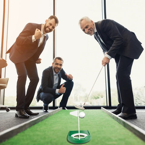 Men using Putting Green Indoor Set Two Pack With Cups And White Flag Portable Golf Practice Kit in office.