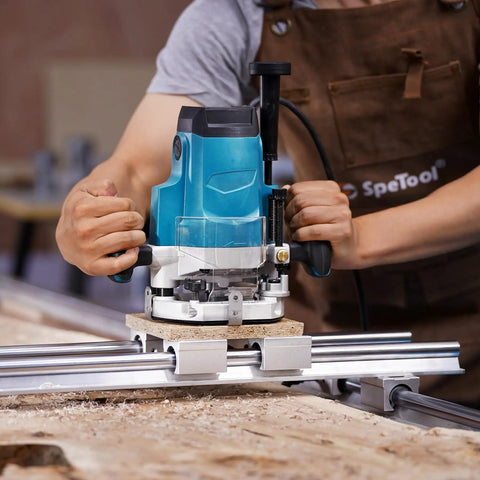 Person using a blue and silver router with a spoilboard on a wood surface, showcasing Knockout Heavy Duty Spoilboard Surfacing Router Bit With Carbide Inserts Ats Coating Serves Butter Smooth Cuts Every Time One Inch Cut Diameter Quarter Inch Shank Works Great With Cnc Planers.