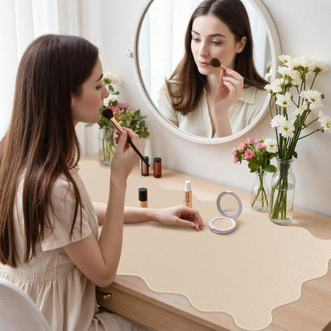 Woman applying makeup on desk with Extra Large PU Leather Desk Pad With Scalloped Edges, Waterproof Non Slip Desk Protector Mat For Office And Home, Large Mouse Pad With Stitched Border, Beige Tone For A Calm, Modern Workspace