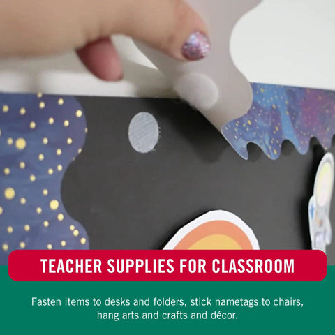 Hand using Thin Clear Fasteners, Low Profile 3/8 Inch Circles on classroom decoration.