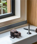 Quiet Roller Cabinet Catch 12 Pack Set for Cabinets and Furniture Doors, copper tone spring latch on windowsill