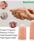 Hands applying 12 Pack Gel Finger Cots For Pain Relief And Fingertip Protection, Silicone Finger Sleeves on fingers, champagne color.