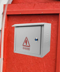 Weatherproof Metal Electrical Junction Box Outdoor Enclosure 300x400x160mm mounted on red wooden wall