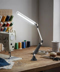 Heavy Duty 110V 16W LED Machine Work Light Featuring An Innovative 180 Degree Adjustable Bracket Designed For Superior Brightness And Flexibility Perfect For CNC Mills Lathes Drill Presses And Industrial Workshop Tasks With Stable Driver And Focus Beam illuminating a sewing workspace with adjustable arm.