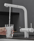3-Way Kitchen Faucet with Pull-Down Hose Ch h Rotating Design Water Filter for Drinking Modern Sink Mixer pouring water into a glass.