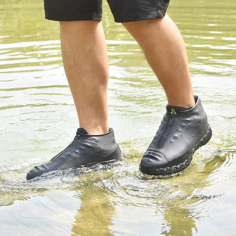 Person wearing Silicone Waterproof Shoe Covers With Zipper, Reusable Rain Overshoes in water, showcasing non-slip tread, Size L