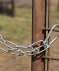 Chain Link Gate Latch with Double Carabiner Ends Stainless Steel securing a rusted gate with metal chain links.