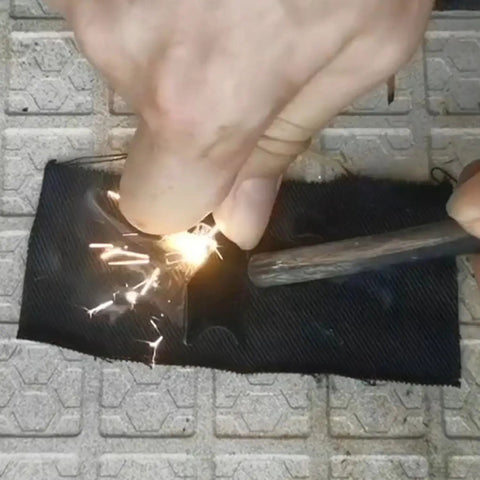 Using Emergency Fire Starter Kit With Char Cloth, Ultra Lightweight 12 Pack, Each 4x4 Inch Piece Cuttable, on a metal grate.