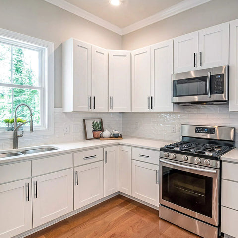 Modern kitchen with Oil Rubbed Bronze Cabinet Pulls Set 25 Pack 5 Inch Overall Length With 3 Inch (76mm) Hole Centers installed on white cabinets.