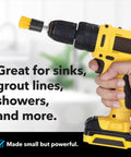 Hand holding cordless drill with yellow brush attachment labeled Four Pack Drill Brush Attachments For Grout And Tile Cleaning Quick Change Shafts Cordless Drill Compatible Yellow With Five Eighths Inch Stiff Bristles Effortless Scrubbing For Grout And Tile Must Have Grout Scrubbing Kit in background.