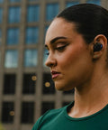 Person wearing Suppressor Bluetooth Earbuds With 25dB NRR Hearing Protection And HD Sound For All Day Comfort 36 Hour Battery Life
