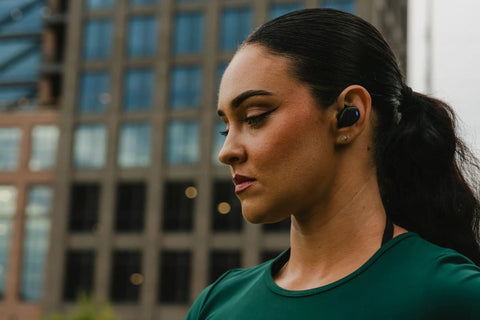 Person wearing Suppressor Bluetooth Earbuds With 25dB NRR Hearing Protection And HD Sound For All Day Comfort 36 Hour Battery Life