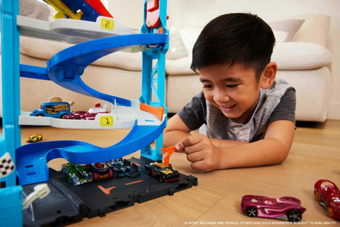 Child playing with Two-In-One City Race Track Set With A Transforming Race Tower From Single Lane To Dual Lane Speedway Includes A Kid-Powered Elevator And 1 Car Amazon Exclusive Toy Playset For Kids.