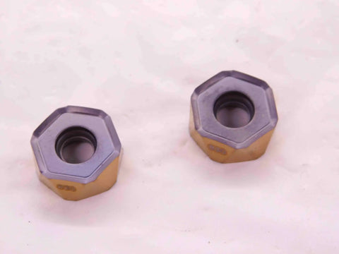Two Pack New H1200 HXCU 0606 HPR IC830 AlTiN And TiN Coated Carbide Inserts with hexagonal design on white background