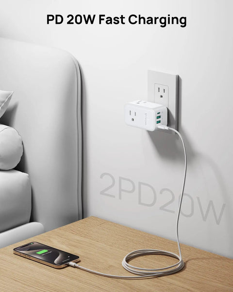 Heavy Duty Multi Plug Outlet Extender With Dual PD 20W USB C Fast Chargers And Three AC Sockets Flex Your Tech Stash charging phone on a coffee table.