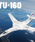 White Swan Fighter Building Block Set 33036 with 1598 pieces, military bomber model kit flying over landscape.
