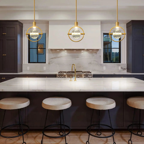 Kitchen island with three Dope Modern Crystal Pendant Light In Gold Brushed Brass Finish With 4.33 Inch K9 Crystal hanging above.