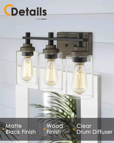Farmhouse 3 Light Vanity Lighting Fixture In Bronze And Matte Black With Clear Cylinder Glass Over Mirror 21 Inch Bathroom Light Bar For Rustic Industrial Vibe, mounted on wall