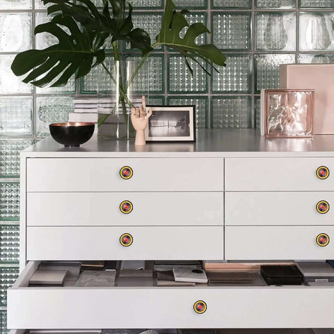Straight Up Game Changing 6 Pack Designer Cabinet Knobs Showcasing Bold Yellow Vinyl Records Woven Into Sleek Black Frames on white dresser.