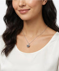 Model wearing silver necklace with large-hole vintage crown charm from 30 Pieces Mini Crown Charms Set For Crafters Mixed Color Vintage 3D Alloy King Crowns Beads Large Hole Spacer Beads For DIY Jewelry Making Necklaces And Bracelets.