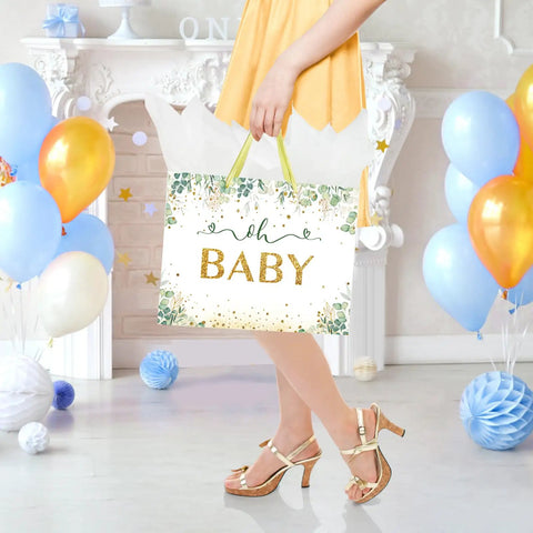 Woman holding 13 Inch Large Baby Gift Bag For Baby Shower Or Birthday with sturdy handle and tissue paper, vibrant green unisex design.