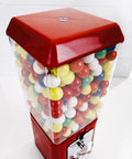 Thinking Process: red metal gumball machine with clear plastic bin and lockable base, filled with colorful candy