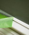 Green Multi Surface Painter's Tape With PaintBlock Technology Pro Grade 1 Inch Wide 0.94 In By 60 Yds blocking paint bleed on wall trim.