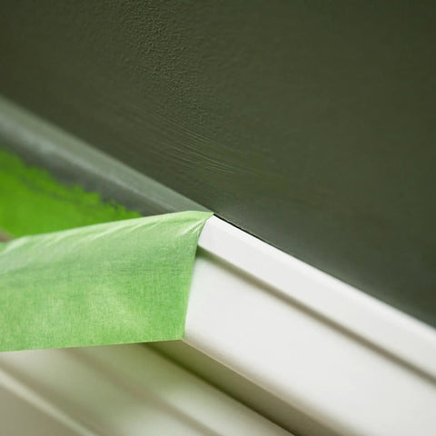 Green Multi Surface Painter's Tape With PaintBlock Technology Pro Grade 1 Inch Wide 0.94 In By 60 Yds blocking paint bleed on wall trim.