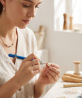 Person using 21 Piece Micro Drill Bit Set With Pin Vise Hand Twist Drill Bits for jewelry making at a workbench.