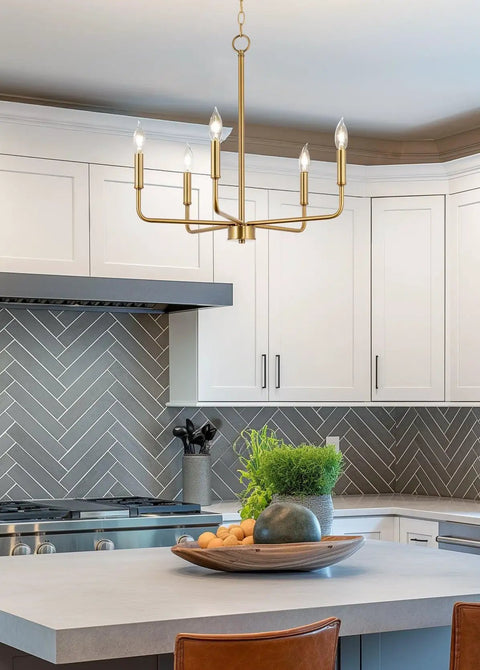 Chic 22 Inch Modern Five Light Gold Chandelier With Candle Style Sockets Open Frame Warm Brass Fixture in a modern kitchen setting.