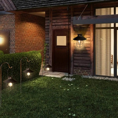 Solar Lantern Outdoor Hanging Light illuminating yard, metal solar lamp with warm white Edison bulb, black finish, vintage marine style.
