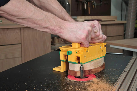 Using GRR RIPPER GR 100 3D Adjustable Table Saw Pushblock 2 Pack on router table for precision cutting, bright yellow tool.