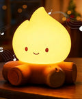 Lit Campfire Night Light Portable Flameless Candle With White Noise Cute Silicone Flame Lamp glowing on table, woodpile design
