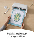 Hands using a Joy Xtra machine with Heat Transfer Paper For Light Tees 20 Sheets 8.5x11 Printable HTV Iron On For Inkjet Printers.