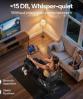 Woman using Recumbent Exercise Bike For Home Gym With Magnetic Resistance, 32 Levels, in living room beside child on sofa.