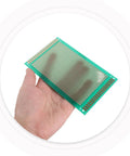 Hand holding a single sided fiberglass PCB breadboard from the 8 pack solderable project board kit for DIY electronics prototyping