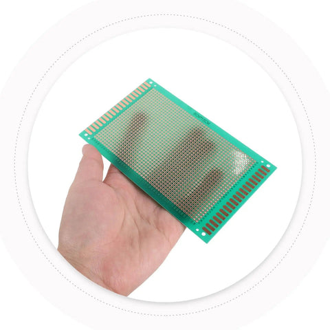 Hand holding a single sided fiberglass PCB breadboard from the 8 pack solderable project board kit for DIY electronics prototyping