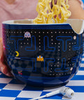 Dope Retro Maze Ramen Dinnerware Set With Ceramic Bowl And Bamboo Chopsticks, 20-Ounce Noodle Bowl For Retro Gamer Kitchens And Everyday Meals At Home, showing noodles being held with chopsticks over a maze-patterned bowl.