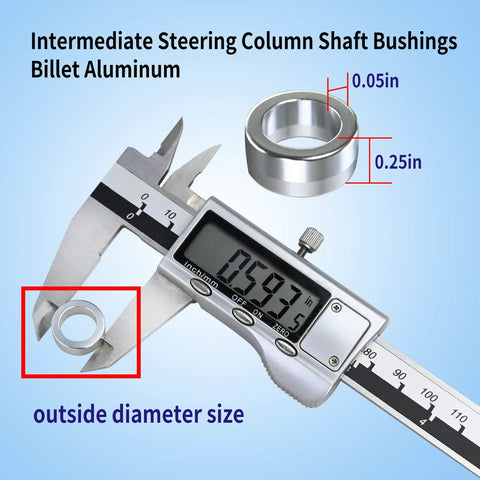 Close-up of four billet aluminum intermediate steering column shaft bushings with caliper measuring outer diameter.