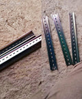 Four Pcs DIN Rail Slotted Design Steel Rail Mounts, 200Mm Long, 35Mm Wide, 7.5Mm High, Galvanized, laid on concrete.