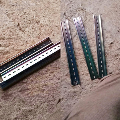 Four Pcs DIN Rail Slotted Design Steel Rail Mounts, 200Mm Long, 35Mm Wide, 7.5Mm High, Galvanized, laid on concrete.