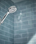 Ignite Chrome Handheld Shower System With Modern Sleek Design And Mirror Like Finish in a contemporary bathroom setting